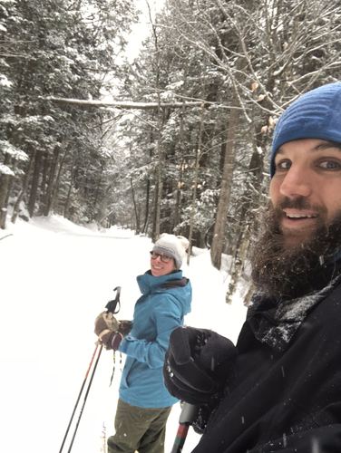 Allie and Chase on skis in a snowy forest