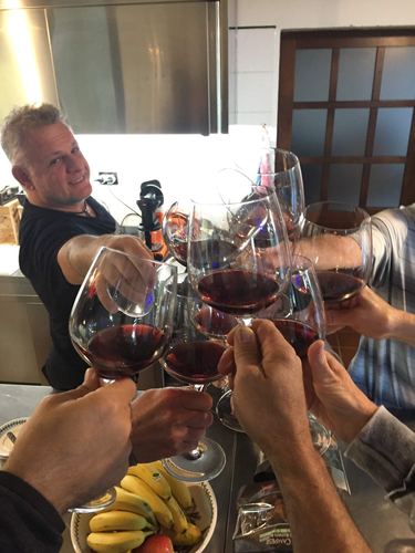 Friends toasting with glasses of red wine
