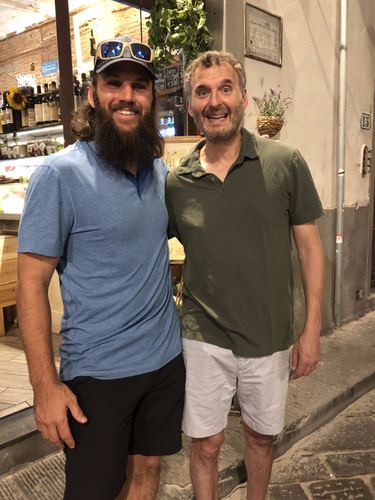 Chase and Phil Rosenthal with arms around each other in a restaurant doorway