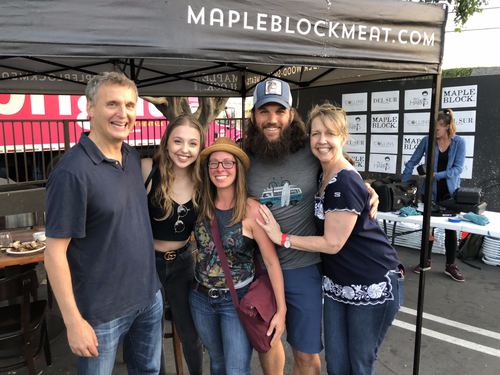 Allie and Chase with Phil Rosenthal, his daughter and his wife at a market tent