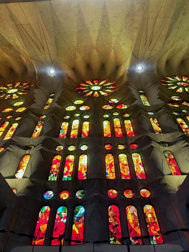 Warm red and orange stained glass inside La Sagrada Familia